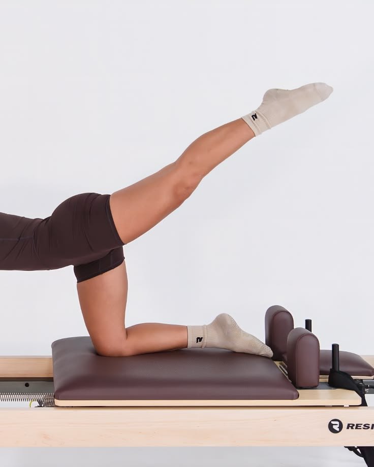 A kneeling leg lift on a reformer