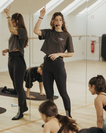An instructor teaching in front of a mirror